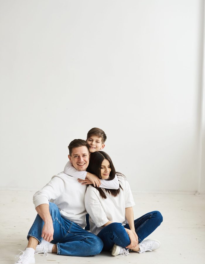 A beautiful young family in the morning bedroomis relaxing and have a fun on a white background